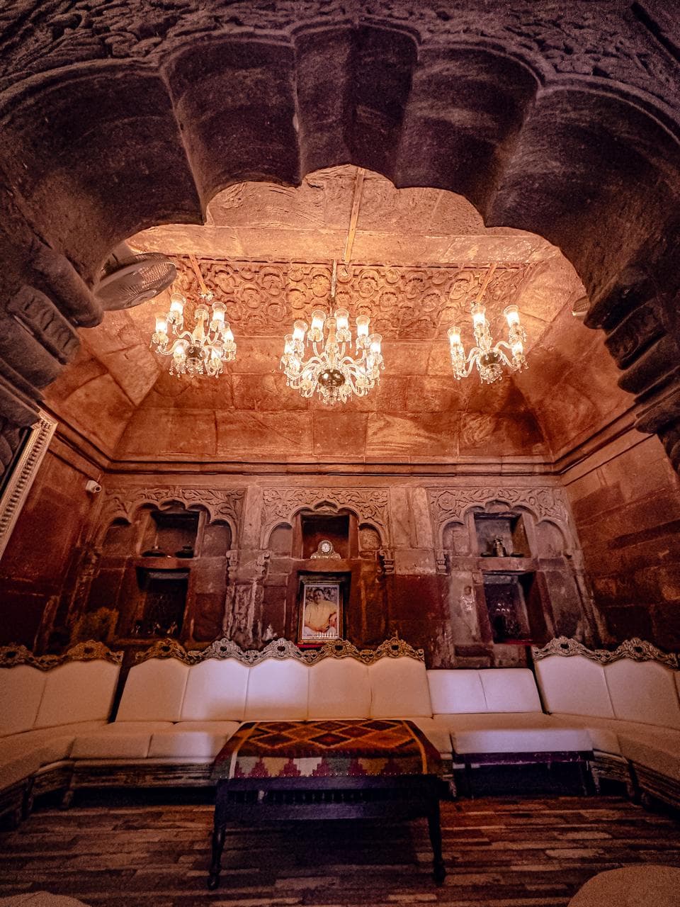 Carved stone pillars and arched corridors inside The Rani Mahal